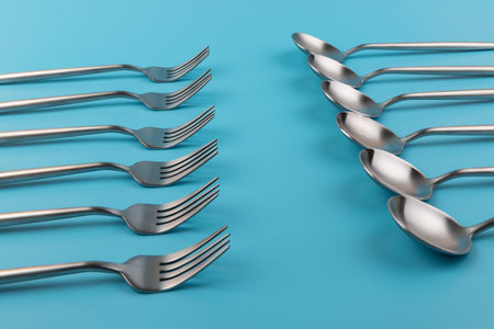 fork, knife, spoon, cutlery on blue background.