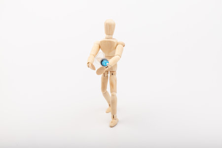 Wooden mannequin with syringe against white background. Coronavirus vaccination. Space for text.の写真素材