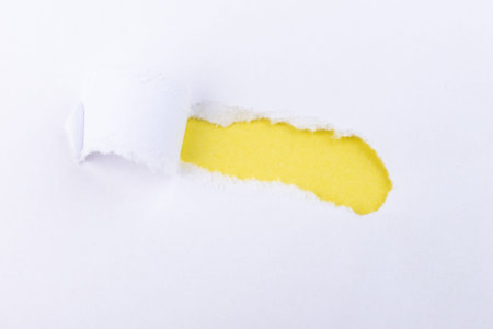 Torn Paper with space for text with a yellow background. Ripped paper. Concept of placing text or othe elements, copy space, mockup.の写真素材