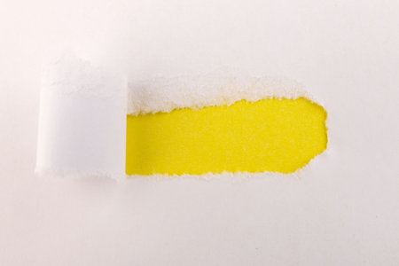 Torn Paper with space for text with a yellow background. Ripped paper. Concept of placing text or...