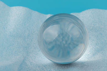 Crystal, transparent ball, sphere on blue and white background. Glass.の写真素材