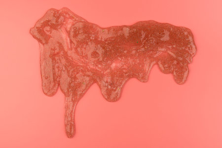 Glitter slime dripping on pink background. Transparent toy. Glossy texture with girly colors of...