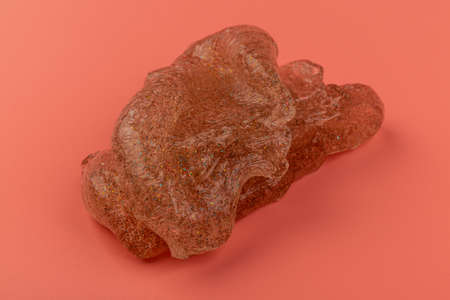 Glitter slime on pink background. Transparent toy. Glossy texture with girly colors of pink.の写真素材