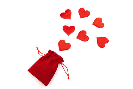 Red silk valentine hearts with red jute bag. A symbol of love handmade. Love and togetherness concept. Design element for holiday, greeting card, postcard and banner.の写真素材