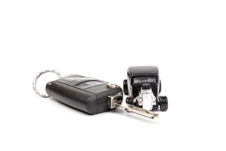 Black car toy whith key isolated on white background. The concept of buying a carの写真素材