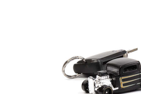 Black car toy whith key isolated on white background. The concept of buying a carの写真素材
