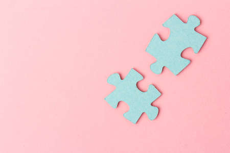 Pieces of jigsaw puzzle are connected on color background.の写真素材