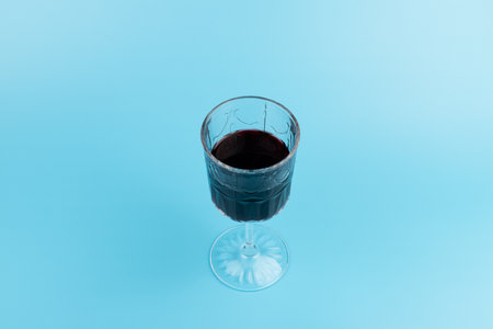 red Wine in glass isolated on blue background, full depth of field.の写真素材
