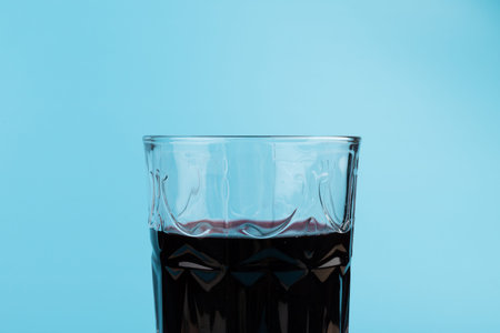 red Wine in glass isolated on blue background, full depth of field.