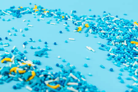 Sprinkle with grains of desserts. Sweet confetti in the form of stars, moon on blue background. Design for holiday designs, party, birthday, invitation.の写真素材