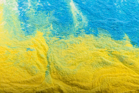 Ukrainian flag colors. Blue and yellow background from holi powder paint.