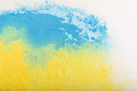 Ukrainian flag colors. Blue and yellow background from holi powder paint.