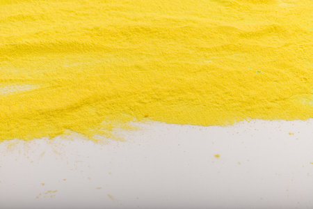 Yellow background from holi powder paint. Indian festival of colors Holi. Abstract powder splatted...