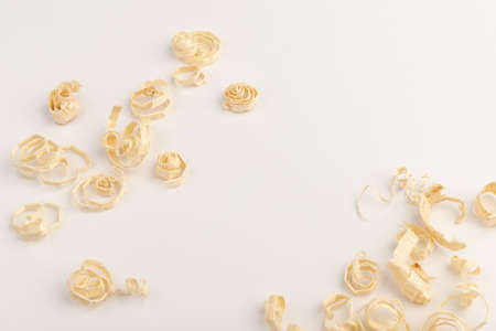 Wood chips isolated on light background. wooden shavings. The concept of woodworking and carpentry.の写真素材