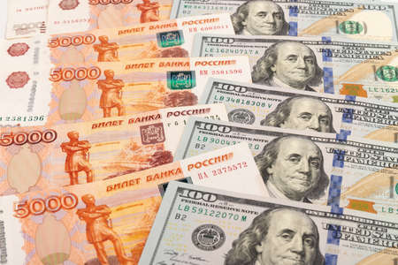 US dollar and Russian ruble. currency exchange. economic crisis. Ruble dollar cash. Hundred dollar bill and 5000 rubles. business and finance. Russia and USAの写真素材