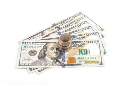 Coin with the inscription in Russian Ruble on the background of one hundred dollar bills. The fall of the Russian currency.の写真素材