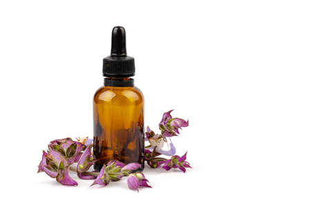 Clary Sage (Salvia Sclarea) Medicinal Herb Plant Distilled Essential Oil in a Glass Container. Isolated on white background.の写真素材