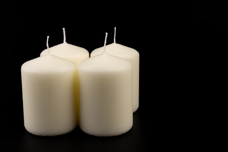 White candles on dark background. lighting device, glowing. Close-up, copy space.の写真素材