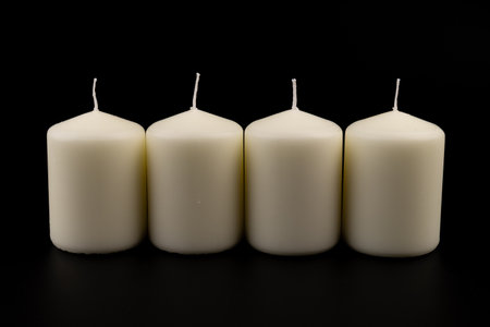 White candles on dark background. lighting device, glowing. Close up, copy space.の写真素材