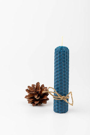 Blue beeswax honeycomb candle isolated on white. natural wax. On light background.の写真素材