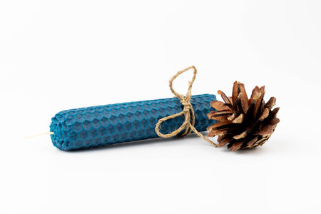 Blue beeswax honeycomb candle isolated on white. natural wax. On light background.の写真素材