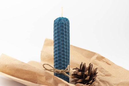 Blue beeswax honeycomb candle isolated on white. natural wax. On light background.の写真素材