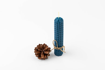 Blue beeswax honeycomb candle isolated on white. natural wax. On light background.の写真素材