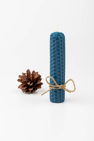 Blue beeswax honeycomb candle isolated on white. natural wax. On light background.の写真素材