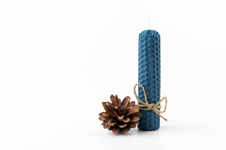 Blue beeswax honeycomb candle isolated on white. natural wax. On light background.の写真素材