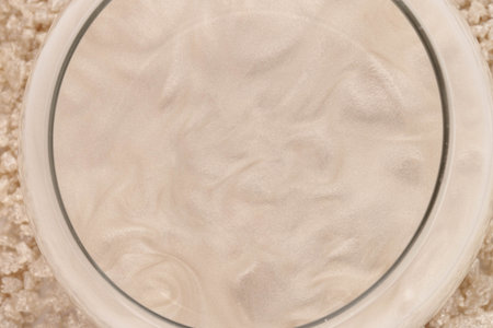Beige glitter shimmer sea salt in water. The idea of home relaxation, aromatherapy and self care.の写真素材