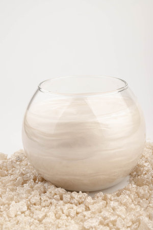 Beige glitter shimmer sea salt in water. The idea of home relaxation, aromatherapy and self care.の写真素材