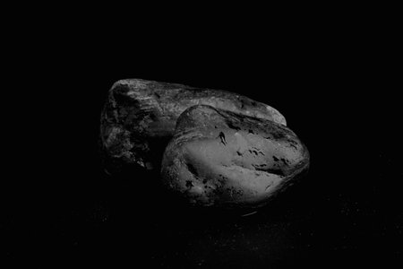 A Blurred Foreground Rock Shelf for a Product Display, Showing Selective Focus to the Background Stones with Natural Worn Texture with Close Detail to the Ancient Small Boulders.の写真素材