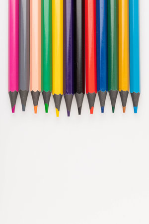 Colorful pencils. Wooden color pencils arranged in row on white isolated background. Selective focus