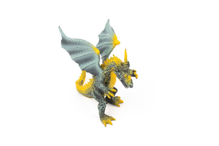 Beautiful and cool green and yellow dragon toy, isolated on white backgroundの写真素材