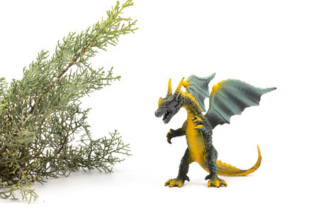 Beautiful and cool green and yellow dragon toy, isolated on white backgroundの写真素材