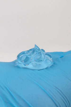Cosmetic or medical gel on a gloved hand on white background. Close up.の写真素材