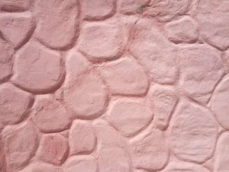 pink cement wall in huge stones, plaster backgroundの写真素材