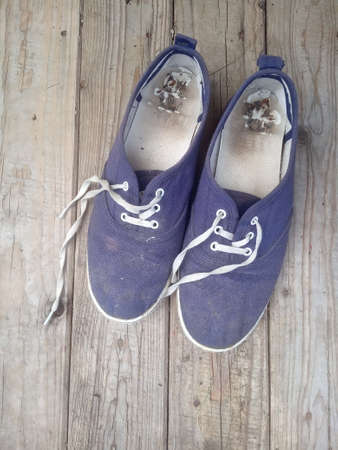 old worn out and dirty blue sneakersの写真素材