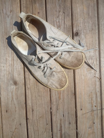 old worn out and dirty white sneakersの写真素材