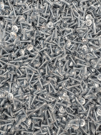 Close up of a pile of self-tapping screws for backgroundの写真素材