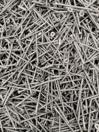 Screws piled up together as a background, closeup of photoの写真素材