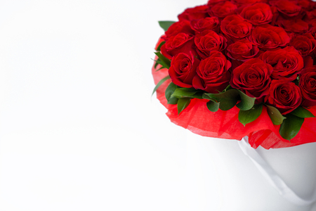 bouquet of red roses in a white box on a white backgroundの写真素材