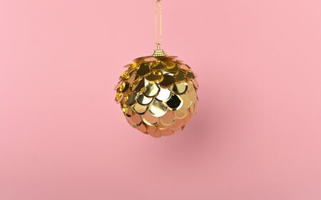 Golden Christmas and holiday ball on pink background, top viewの写真素材