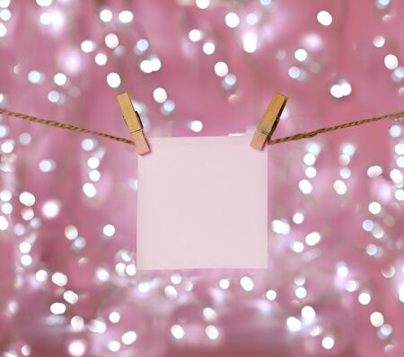 sheet of paper for notes hanging clothespinsの写真素材