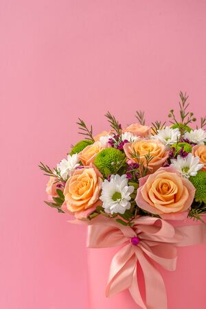 Beautiful bouquet in a pink luxury present box, isolated on pink backgroundの写真素材