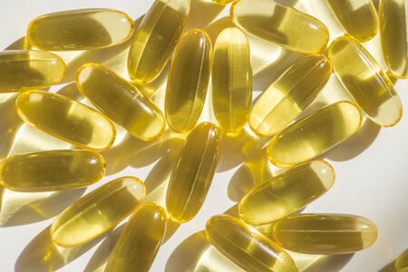Close up capsules of fish fat oil , omega 3, vitamin Healthy food diet. Nutritional supplementの写真素材