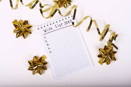 empty notebook decorated with gold Christmas decorations on the white background. Top viewの写真素材