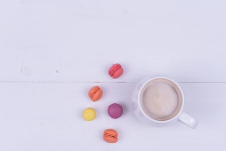 White Cup of fragrant cappuccino with macaroni cakes on white background, top viewの写真素材