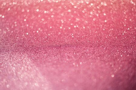 beautiful pink sequins on the glitter sparkle of sun light background with blur bright bokehの写真素材