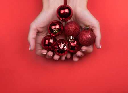 red Christmas balls on a red background, top view. Preparing for the new year and Christmas. Red background.の写真素材